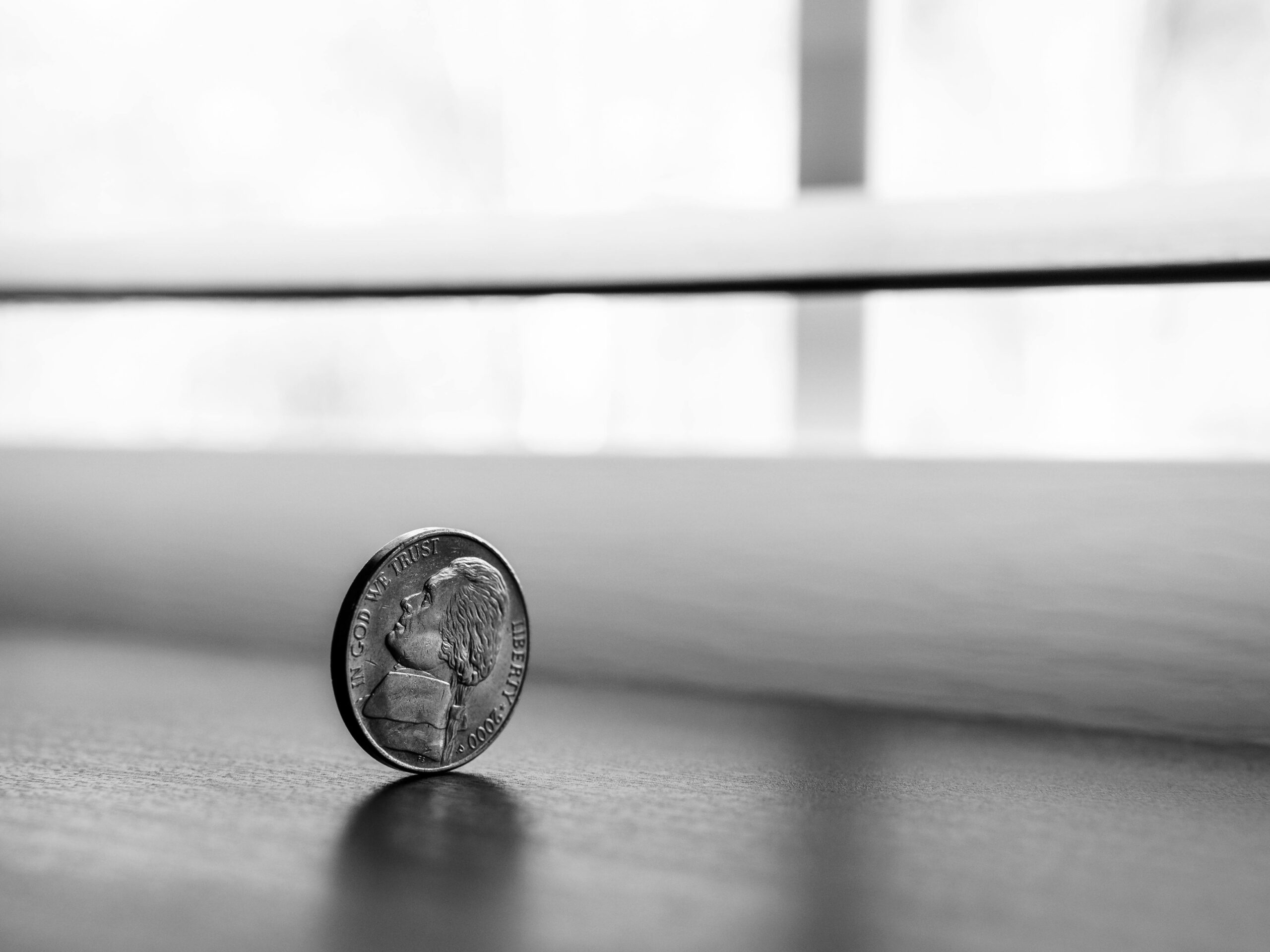A coin standing up on its side with the "head side" facing us.