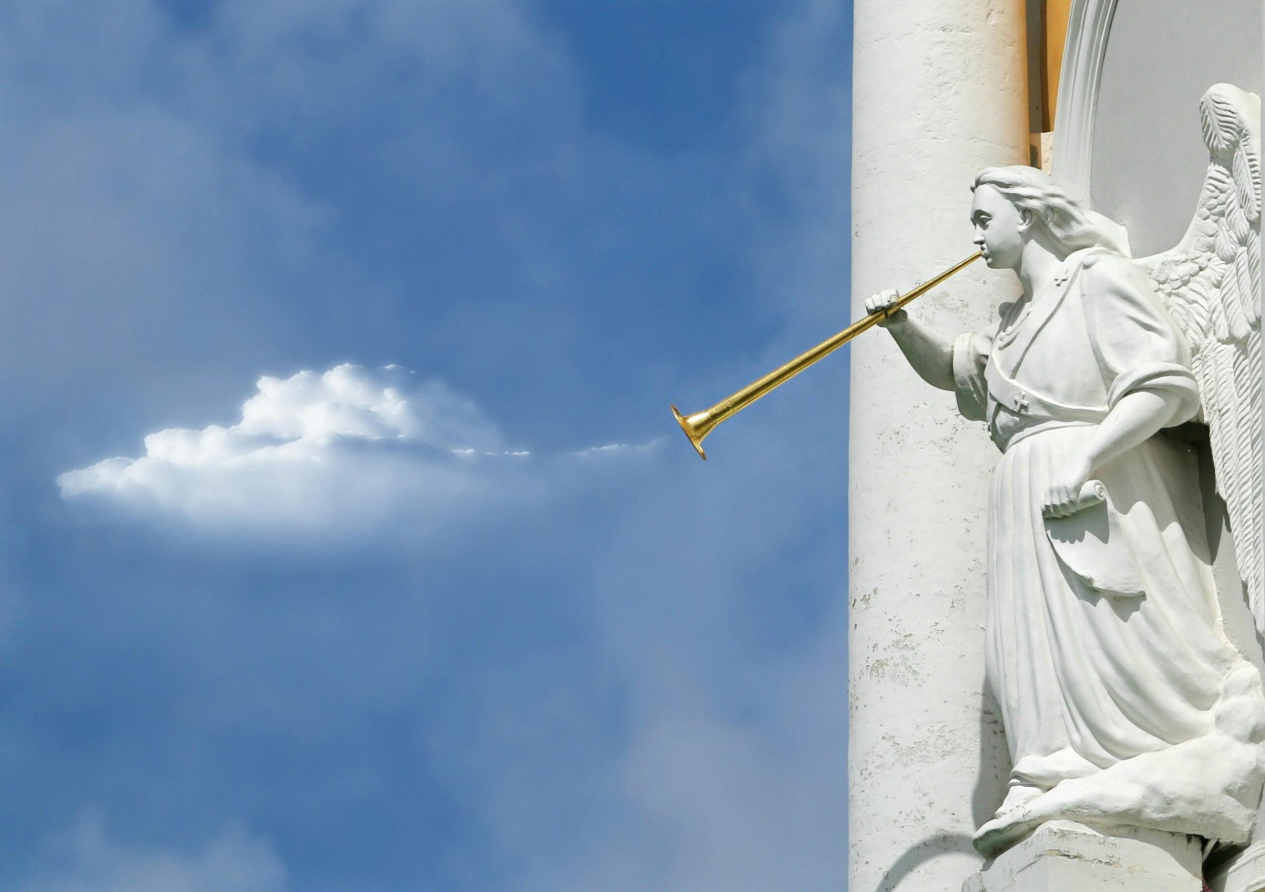 A statue of an angel blowing a trumpet.