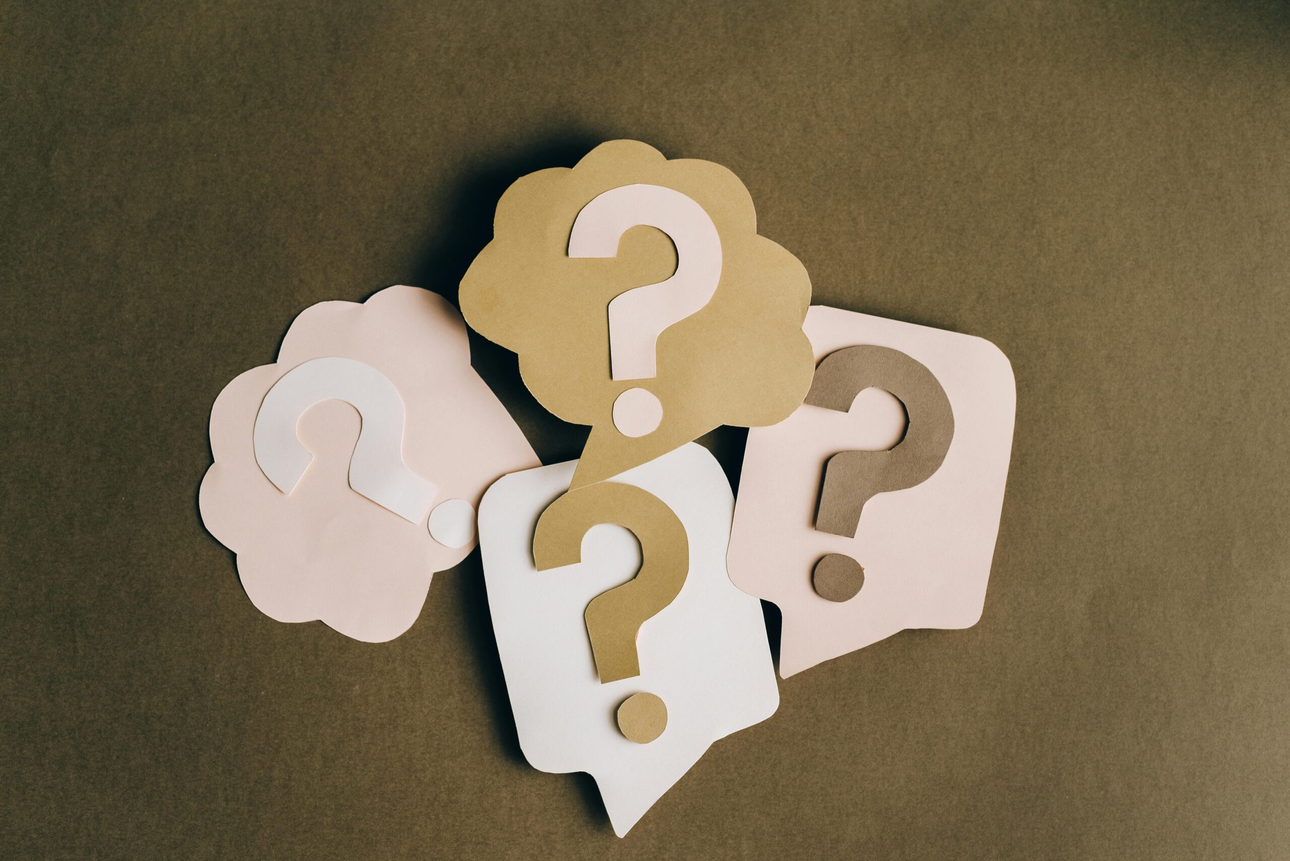 Multiple cut-outs of question marks.