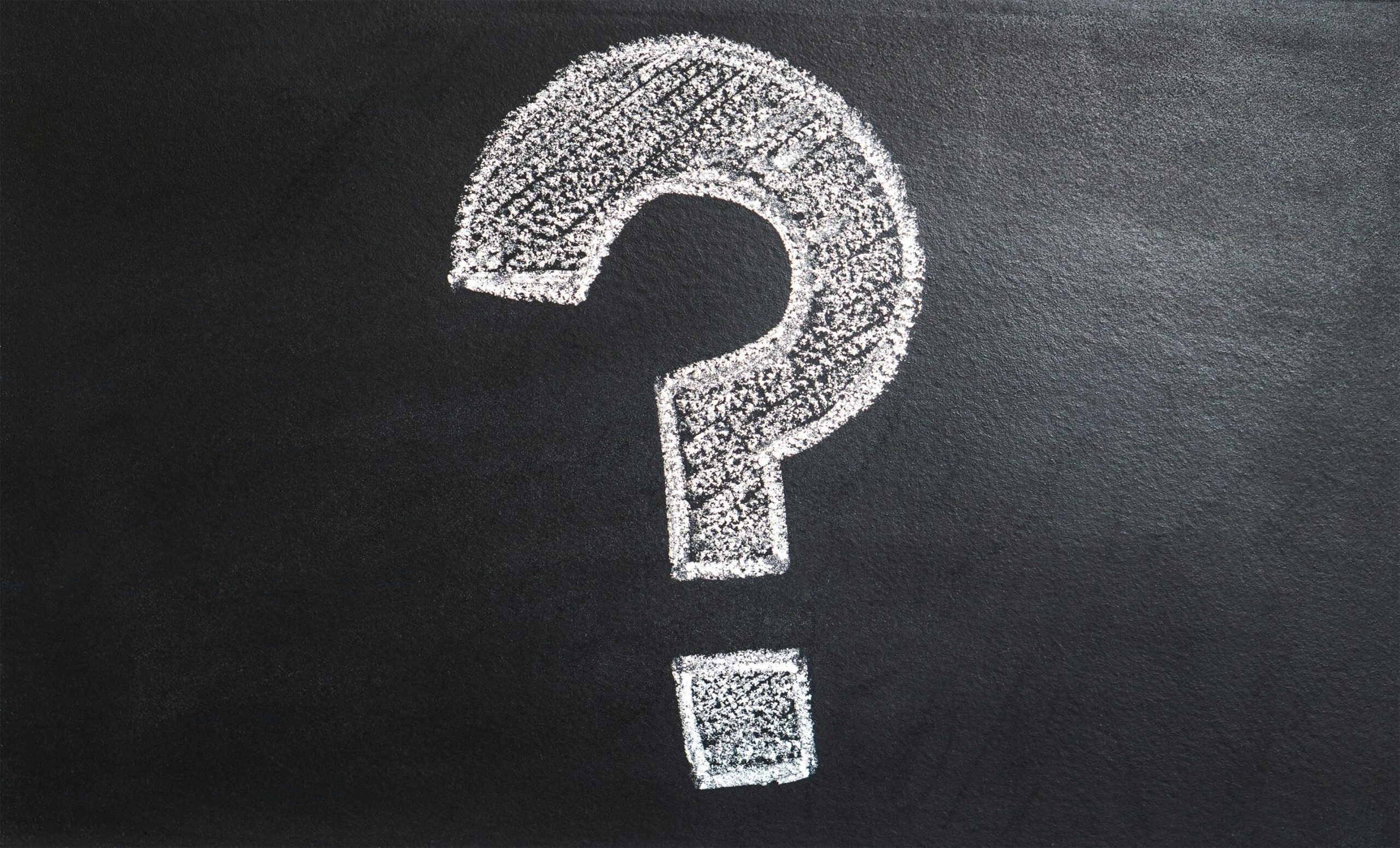 A question mark drawn on a chalkboard.